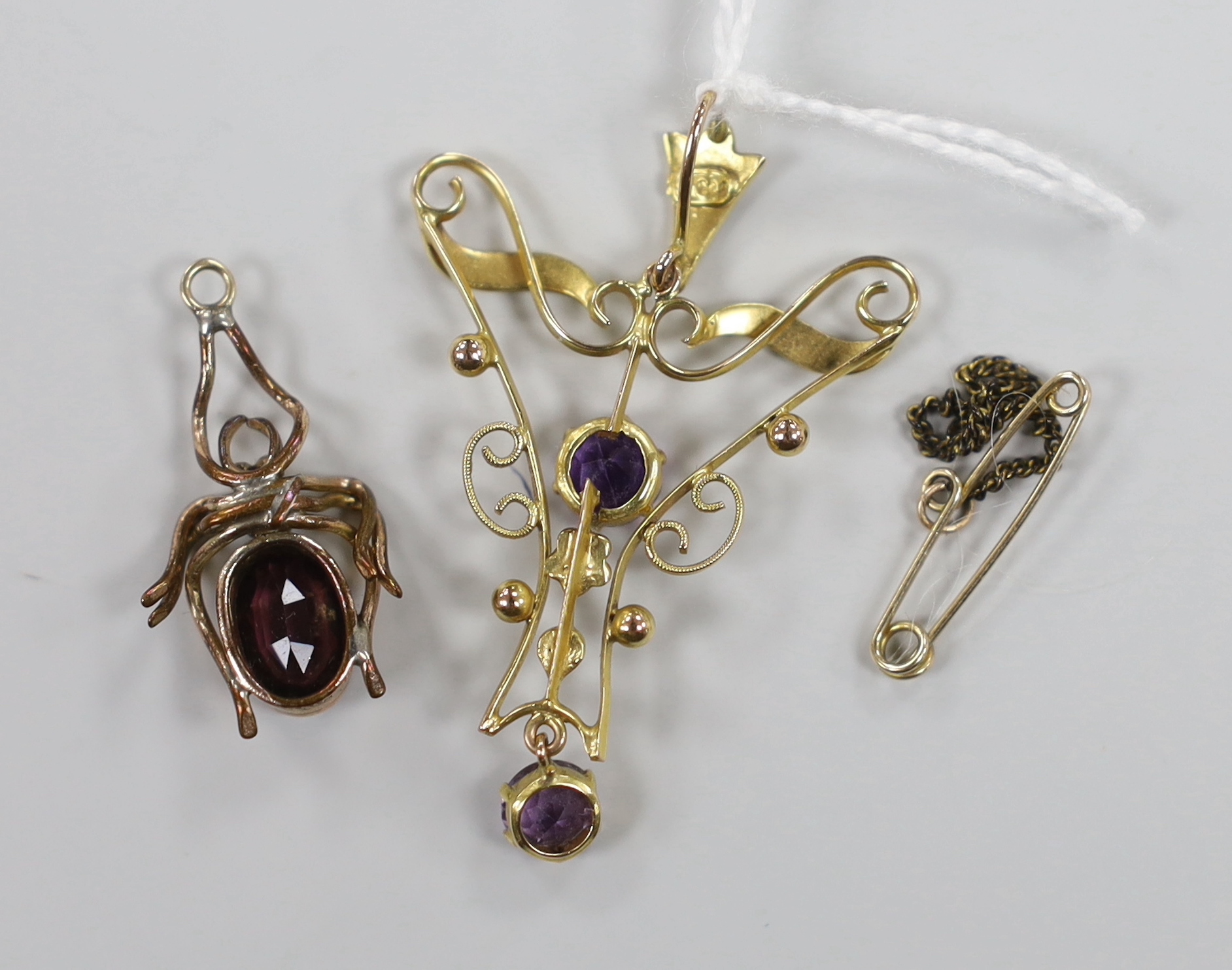 An Edwardian 9ct amethyst and seed pearl set drop pendant, 4cm, gross weight 1.7 grams and a gilt metal and paste set bug pendant.